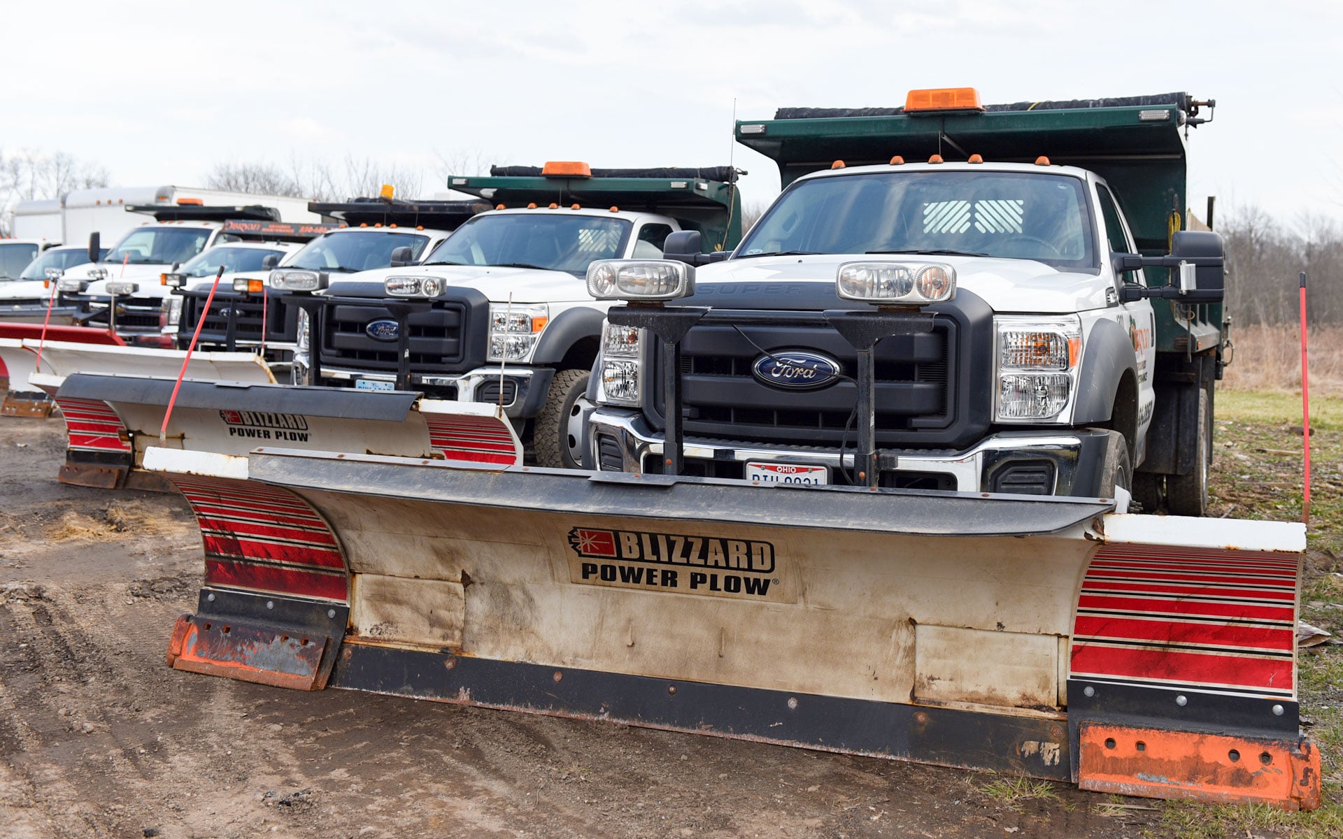 O'Bryan plow trucks lined up ready to run at the Stow yard